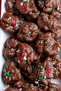 chocolate covered pretzels with sprinkles in a white box on a table