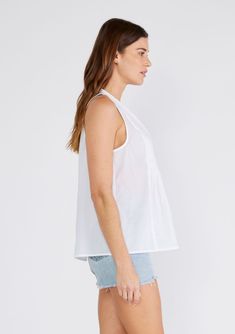 A relaxed bohemian tank top with pleated details and a roomy tent silhouette. Relaxed fit Sleeveless Hip length V-neckline Pleated details Spring tank top A versatile cotton tank top for spring and summer. Featuring delicate pleated details, a flattering v-neckline, and a subtle flare silhouette. Pair it with denim shorts for a casual look, or dress it up with trousers for a more polished feel. Model is 5'9, wearing a size S.Style: I-15289W-SNO Unlined Summer Tops, Unlined Summer Daywear Tops, Unlined Summer Tops For Daywear, Unlined Tops For Summer Daywear, Unlined Spring V-neck Top, Flowy Sleeveless Tops For Daywear, Spring Relaxed Fit Unlined Tops, Chic Unlined Top For Daywear, Relaxed Fit Unlined Tops