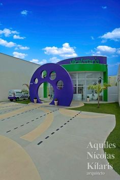 a large purple object sitting in front of a building