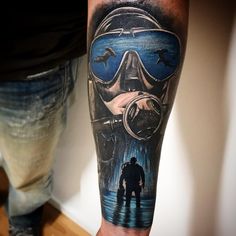 a man's arm with an image of a person in a gas mask on it