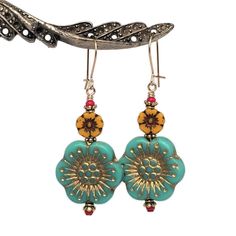 "Large, colorful Anemone flower earrings in a retro shades of aqua and marigold.  Detailed, European pressed-glass flower beads are matched with tiny, vintage, ruby red seed beads.   22K gold-plated spacers add texture to a look which is lively and fun. Quality 14K gold-filled ear wires - choose from kidney or French.  14K gold-filled head pins.  Length is 1 7/8\". All my Etsy jewelry offerings are designed and created by me.  As an independent craftsperson, I value your patronage.  Please use c Vintage Turquoise Flower Earrings, Vintage Turquoise Dangle Flower Earrings, Bohemian Green Flower Charm Earrings, Turquoise Nickel Free Flower Earrings, Nickel Free Turquoise Flower Earrings, Vintage Turquoise Czech Glass Earrings, Gold Flower Earrings With Czech Glass, Handmade Turquoise Flower-shaped Earrings, Turquoise Flower Charm Earrings For Gift