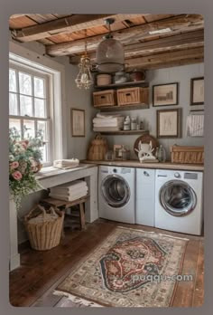 a washer and dryer sitting in a room next to a window with pictures on the wall