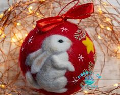 a red ornament with a white rabbit on it