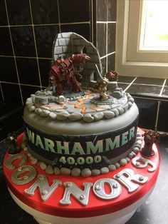 there is a cake that looks like it has warhammer written on the top and sides