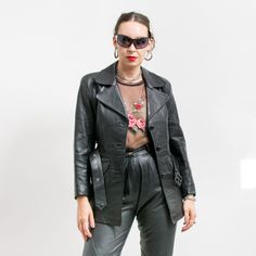 Vintage women's leather jacket in black - lined - 2 outer pockets - belt included - materials: genuine leather SIZE from the label: M best fits women: S/M MEASUREMENTS: shoulder to shoulder: 18 inches (45 cm) bust: 38.5 inches (98 cm) hips: 38 inches (96 cm) length: 28 inches (71 cm) sleeve length from the shoulder seam: 22 inches (56 cm) The model is 5'9" (174 cm), measures 35-27-38 (90-69-96 cm) and typically wears clothing in size M CONDITION - 9/10 - The jacket in great vintage condition. Black Leather Jacket With Belt Loops For Fall, Fitted Black Leather Jacket With Belt Loops, Spring Leather Belted Biker Jacket, Belted Leather Jacket For Office, Fitted Leather Jacket With Belt Loops For Spring, Office Leather Belted Jacket, Spring Leather Biker Jacket With Belt Loops, Black Leather Outerwear With Belt, Fitted Leather Jacket With Belt Loops