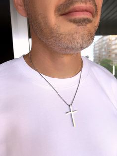 Men's Cross Pendant Necklace is a durable silver-colored box chain made of hypoallergenic stainless steel. A great choice as a gift for him. Dimensions: Cross - height 45 mm, width 24 mm, thickness 4.2 mm; Chain - thickness 2 mm, length of your choice. To choose the length of the necklace: 1. Prepare a thread and a ruler. 2. Take a thread of the desired necklace length. 3. Try it on in front of a mirror to see how it will look on your neck. 4. Unwind the thread and measure its length with a ruler. Following these steps, you can accurately determine a comfortable and stylish necklace length. Features: - Material: hypoallergenic stainless steel. - Design: classic rope chain. - Durability: Resistant to tarnishing, corrosion, and daily wear. - Comfort: Suitable for sensitive skin due to hypoal Durable Silver Jewelry Gift, Classic Durable Silver Jewelry, Modern Silver Durable Jewelry, Durable Silver Necklace For Gift, Silver Hypoallergenic Necklace For Father's Day, Hypoallergenic Silver Jewelry, Silver Necklace Gift, Best Gifts For Him, Mens Crosses