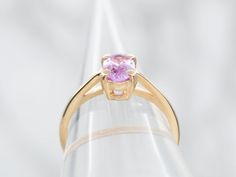 This ring's focal point is the sweet cherry blossom pink sapphire set at the center! The simple engagement mounting, with balanced shoulders and high-mounted prongs, is the perfect frame for this stunning stone and will sit nicely next to a variety of wedding band styles. Metal: 14K Yellow GoldGem: Pink Sapphire .99 CaratsGem Measurements: 4.8 x 6.9 mm, OvalRing Size: 6Marks: "14K*" Stamped on the inside band Pink Brilliant Cut Amethyst Wedding Ring, Wedding Pink Brilliant Cut Amethyst Ring, Elegant Pink Sapphire Round Band Ring, Pink Brilliant Cut Round Amethyst Ring, Pink Amethyst Ring With Brilliant Cut, Pink Brilliant Cut Amethyst Ring, Fine Jewelry Pink Sapphire Solitaire Rings, Pink Sapphire Ring With Round Cut Center Stone, Pink Sapphire Ring With Center Stone