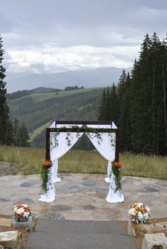 an outdoor ceremony set up in the mountains