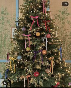 a decorated christmas tree with ribbons and ornaments