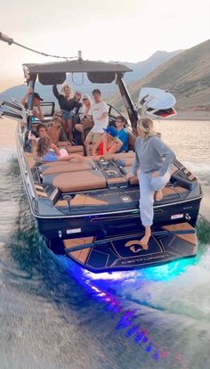 a group of people riding on the back of a boat