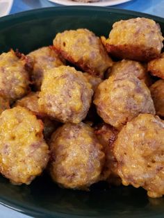 a plate full of meatballs sitting on a table