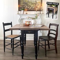 a dining room table with two chairs and a painting hanging on the wall above it