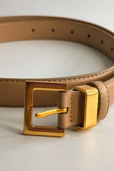 Front close up view of the Iris Taupe Slim Square Buckle Belt which features taupe Leather Fabric  and Gold Square Adjustable Buckle Gold Belts With Buckle Closure For Business, Gold Belt With Rectangular Buckle For Business, Gold Belt With Rectangular Buckle, Gold Belt With Buckle Closure For Formal Occasions, Elegant Gold Belt With Buckle Closure, Modern Gold Belt With Buckle Closure, Elegant Formal Belt With Buckle Closure, Adjustable Formal Belt With Buckle Closure, Formal Adjustable Belts With Buckle Closure