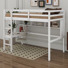 a white bunk bed sitting on top of a hard wood floor next to a desk