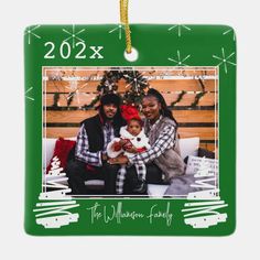 a family photo ornament hanging on a christmas tree