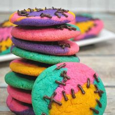 colorful cookies with chocolate sprinkles stacked on top of each other