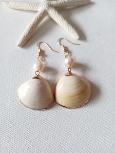 These beautiful earrings are made from real gold plated seashells and freshwater pearls. The seashells are around 20-25mm long and the freshwater pearls 8 mm. The ear-wires on these earrings are gold-filled.  Each item is carefully packaged in a beautiful jewellery box ready as a gift. If you would like to add a personalized note with your order, just write a note at checkout and I will send a small card with your gift to the recipient. If you need a bigger quantity or any customized jewellery for your very special occasion (birthdays, weddings, bridal showers or any other event), please send me a message and I'll be glad to help. Gold Shell With Matching Earrings Gift, Gold Shell Earrings For Wedding, Gold Pearl Earrings With Shell - Gift, Ocean-inspired Shell Earrings For Gifts, Yellow Gold Shell-shaped Earrings Gift, Sea Shell Earrings, Beach Wedding Jewelry, Natural Jewelry, Mermaid Jewelry