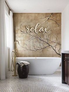 a bathroom with a large bathtub next to a wall that says relax on it