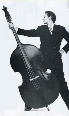 a man in a suit and tie holding a bass