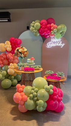 an assortment of balloons and cake on display