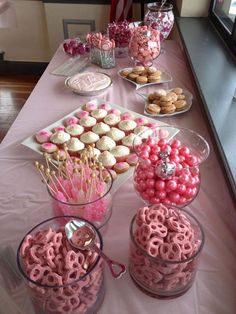 the table is set up with cupcakes and candy