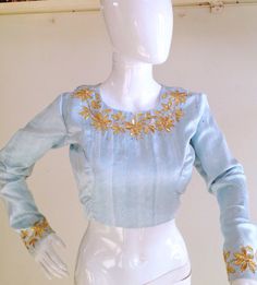 Pure sky blue raw silk blouse with gota patti work . Work is done in gold gota leaves, sequins and gold metallic thread.Custom fitted. -Measurements sheet will be sent to you once you order( Standard sizing also available) -Custom colors available -Work on front, back and sleeves. Please convo me if you're have any specific requirements. This blouse can be done with or without the bust cup inserts . The blouse is fully lined is cotton. Usual turn around time is 1-2 weeks, but we may be able to a Gold Long Sleeve Lehenga With Gota Work, Fitted Light Blue Blouse Piece For Wedding, Blue Tops For Diwali Reception, Blue Blouse Piece With Gota Work For Diwali, Gold Silk Blouse Piece With Gota Work, Festive Blue Blouse With Gota Work, Festive Blue Blouse Piece With Gota Work, Festive Light Blue Embroidered Choli, Designer Gold Blouse Piece With Gota Work