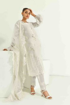 SKU: 1704 Price for Shirt lining and Pants Pure white silk net adorned with laces and hand embroidery of pearls, crystals, and resham and sequence work. The hemline is also adorned with organza and finished with lace details. The sleeves are made to perfection with lace details incorporated with self thread embroidery with cutwork. The gorgeous thread embroidered cutwork dupatta with 3D floral scattered all over can be added to this ensemble Festive Embellished Lace Sets, White Silk Sets With Sheer Dupatta, White Silk Set With Sheer Dupatta, White Long Sleeve Sets With Sheer Dupatta, Embellished Lace Sets For Wedding, Embellished Lace Wedding Sets, Wedding Lace Embellished Sets, White Silk Set With Pearl Embroidery, Elegant Embellished Cream Dupatta