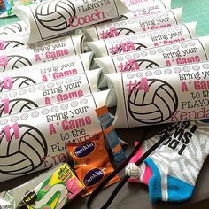 volleyball balls, candy bar wrappers and other items are laid out on a table