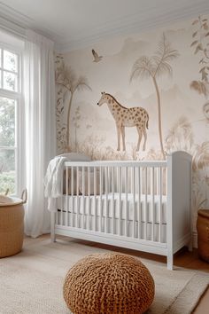 a baby's room with a giraffe wallpaper and white crib