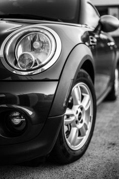 the front end of a black and white mini car