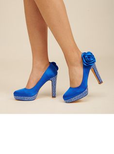 a woman wearing blue high heels with a rose on the heel and diapered toe