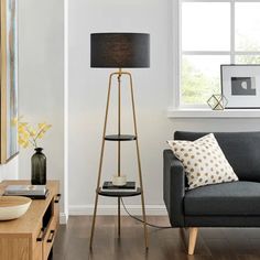 a living room filled with furniture and a lamp