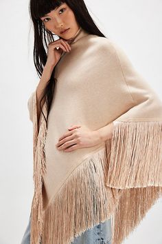 Forever cool and classic, this stand-out poncho is featured in a staple silhouette with turtle neckline and fringe-adorned bottom trim to add the loveliest layer to absolutely every look. | River Walk Poncho Jacket by Understated Leather at Free People in Tan, Size: M/L Fall Fringe Cape Outerwear, Fringe Cape Outerwear For Fall, Oversized Fringe Cape For Fall, Winter Cape With Tassels, Winter Fringe Cape Outerwear, Fringed Long Sleeve Poncho For Fall, Long Sleeve Fringe Poncho For Fall, Fringe Long Sleeve Poncho For Fall, Chic Fall Poncho Cape