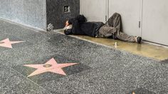 a man laying on the ground in front of a star