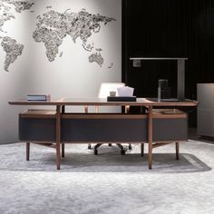 an office desk with a world map on the wall