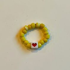 *Size: One Size *Color: Yellow *Product Detail: Good Quality Beads. Stretchy Elastic Band. 1 Red Heart Beaded Ring Yellow Beads. (Message For Customized Letters & Bead Color Preferences) *Condition: 100% Handmade. Brand New. *Note: Customizable Bracelet. Made To Order In 2-3 Days. Message Preference For Custom Colored Beads. Will Re-List Item Custom Ordered. *Note: Great Gifts For Party Bags. Message For Multiple Rings. Yellow Beaded Bracelets With Heart Beads For Gifts, Cute Yellow Jewelry With Colorful Beads, Yellow Adjustable Jewelry For Valentine's Day, Yellow Jewelry With Letter Beads For Gift, Yellow Heart Beads Jewelry For Valentine's Day, Yellow Heart Beads Jewelry For Gift, Cute Yellow Jewelry With Letter Beads, Yellow Jewelry With Heart Beads For Valentine's Day, Red Beaded Rings For Gifts