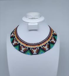 This beautiful beaded necklace is hand-woven by the women of the Embera Chami Indigenous Tribe of Colombia Handmade Multicolor Southwestern Beaded Necklaces, Handmade Southwestern Multicolor Beaded Necklaces, Artisan Beaded Adjustable Bib Necklace, Artisan Beaded Bib Necklace With Adjustable Fit, Southwestern Style Necklaces With Large Beads, Multicolor Southwestern Style Necklaces, Southwestern Handwoven Beaded Necklaces For Festivals, Southwestern Style Beaded Necklace For Festivals, Southwestern Style Handwoven Beaded Necklace For Festivals