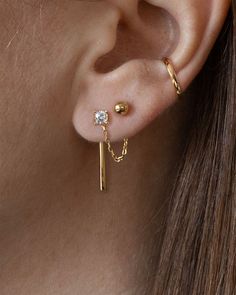 You save $120 and get free shipping with this set. The combinations are endless with this Earring Capsule. This set includes all 8 original essentials designs: Arc ear jackets Chain ear jackets (small) Circle hoop ear jackets Bar ear jackets Ball stud earrings Emerald stud earrings Solitaire stud earrings Stripe stud earrings Handcrafted in 14K gold vermeil - a thick 14K gold layer on sterling silver Emerald cut earrings and solitaire stud earrings are set with premium, lab-created cubic zirconi Classy Ear Piercings Chic, Double Ear Piercing Ideas Simple, Third Piercing Ideas, Multiple Earrings Inspiration, Classy Earring Stack, Modern Stackable Gold Earrings, Minimalist Round Stackable Earrings, Everyday Stackable Gold Cartilage Earrings, Ear Piercings Chain