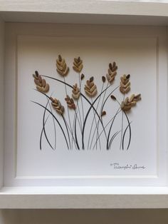 a white frame with some brown and black flowers on the inside, and leaves in the middle