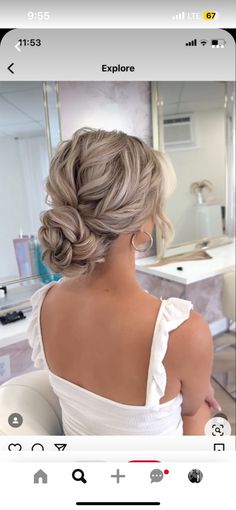 the back of a woman's head, with her hair in a low bun