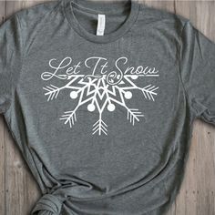 a t - shirt that says let it snow on the front, and an arrow in the back