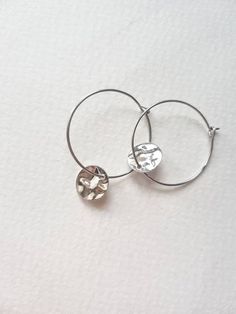 Round Minimalist Hoop Earrings with Tiny Hammered Coin CharmsSo simple yet so chic to wear daily and forget about you having them on! They are feather light but dangle so beautiufuly.Silver plated wire earrings with hammered coin charms.Nickel and lead free.{Size}25 mm round hoops10 mm charms✅ Also available in gold ( 35 mm large) or in huggie hoop style (12 mm).♥ Here you can see other jewelry:https://etsy.me/38kb2uS♥ Please read my shop policies before purchasing: https://etsy.me/2NOS96J♥ Back Minimalist Metal Hoop Wrap Earrings, Modern Handmade Metal Hoop Earrings, Minimalist Hammered Metal Hoop Earrings, Stacking Earrings, Unique Hoop Earrings, Stacked Earrings, Wire Jewelry Designs, Tree Pendant, Feather Light