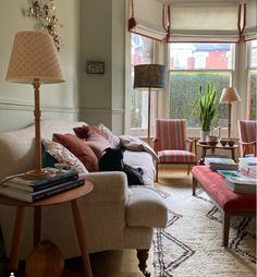 a living room filled with furniture and lots of windows