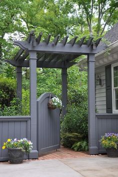 an image of a small garden with flowers on the fence and in front of it