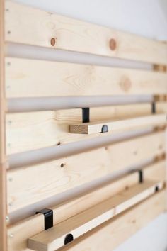 a close up of a wooden wall with metal bars on the bottom and wood slats above it