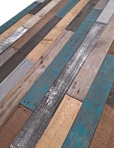 wood planks are arranged in different colors and sizes, including blue, green, brown, and white