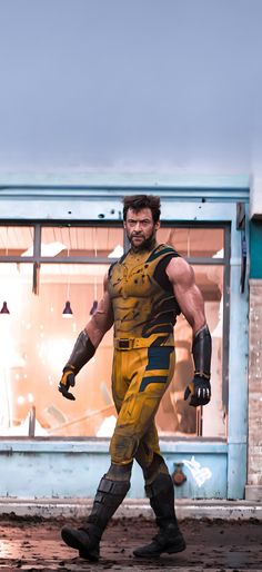 a man dressed as wolverine in front of a storefront with his hands on his hips