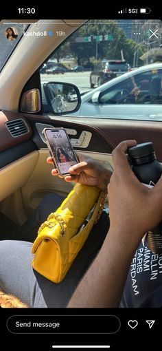 a person sitting in a car holding a cell phone