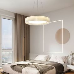 a bedroom with a large bed and a round light fixture hanging from the ceiling above it