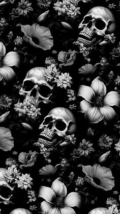 black and white photograph of skulls surrounded by flowers